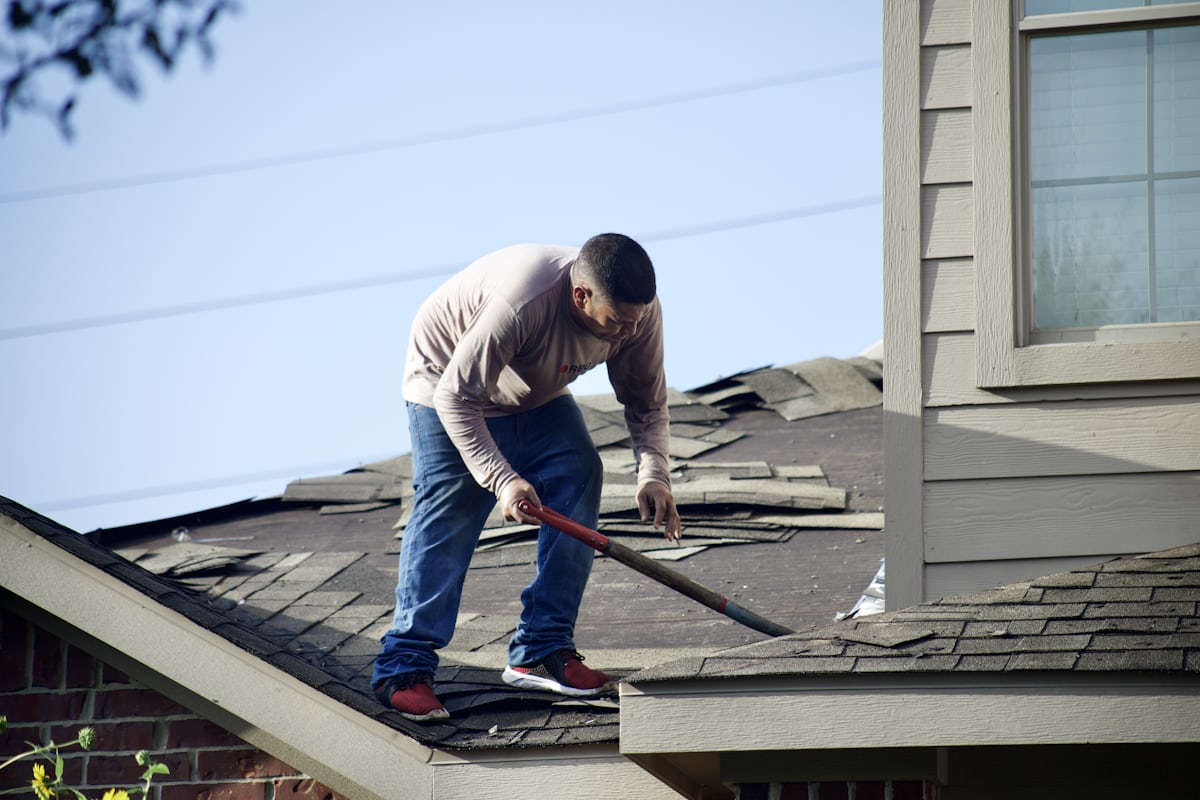 Roofing contractor conducting roof inspection — understanding what affects roof replacement cost starts with a proper assessment