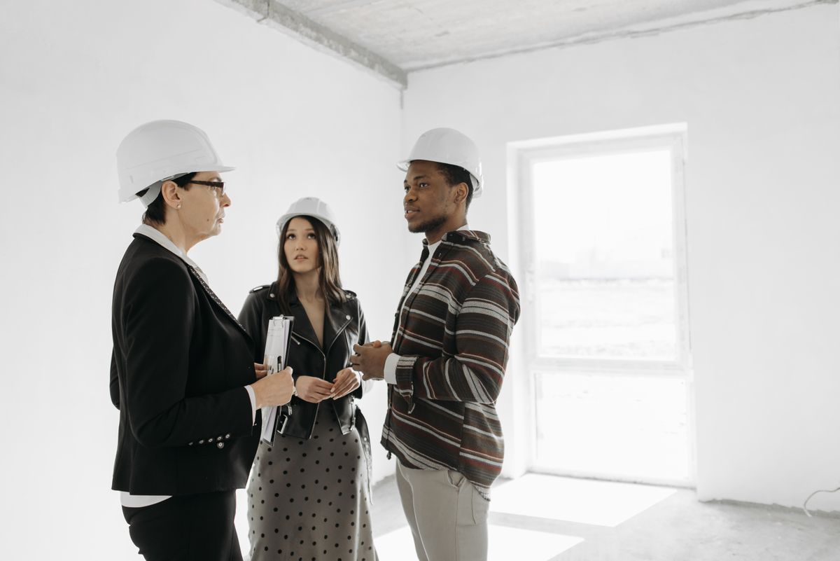Homeowner reviewing roofing quote with contractor — understanding how much does it cost to replace a roof before signing